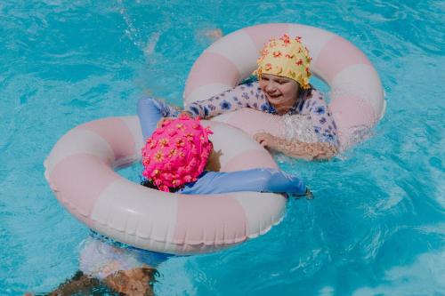 a girl in a pool in an inflatable ring in the water at Mulwala Resort in Mulwala