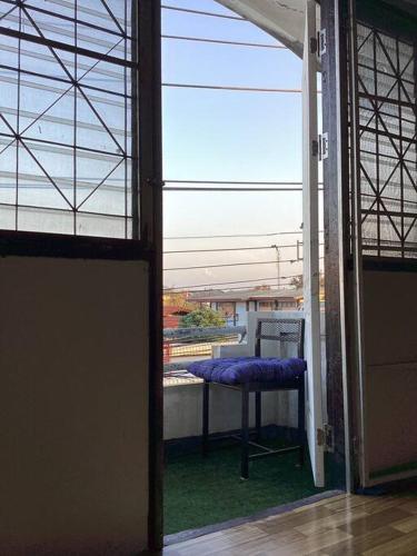 an open door to a balcony with a purple seat at My room Net 1 in Lamphun