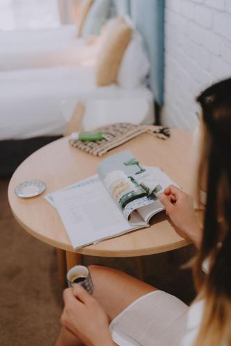 a woman sitting at a table with a book at Mulwala Resort in Mulwala