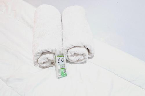 a pile of towels and a tube of toothpaste at HKP Homestay RedPartner Blitar in Blitar