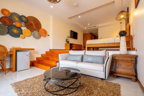 a living room with a couch and a bed at Ocean Pearl Seaview Residence in Rawai Beach