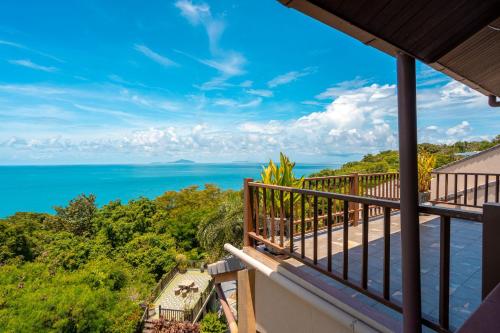 a view of the ocean from the balcony of a house at Ocean Pearl Seaview Residence in Rawai Beach