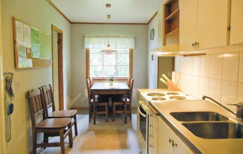 a kitchen with a table and a dining room at Gorgeous Home In Gislaved With Wifi in Våthult