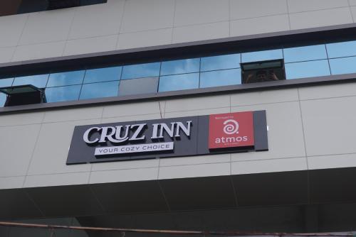 a sign on the side of a building at Cruz Inn calicut in Kozhikode