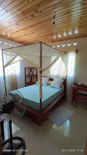a bedroom with a bed with a wooden ceiling at Villa Ste Marie in Sainte Marie