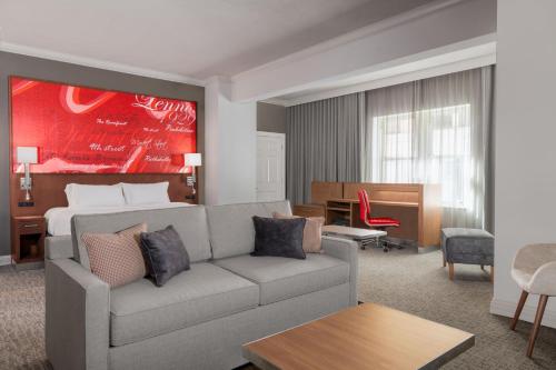 a living room with a couch and a bed at Courtyard St. Louis Downtown/Convention Center in Saint Louis