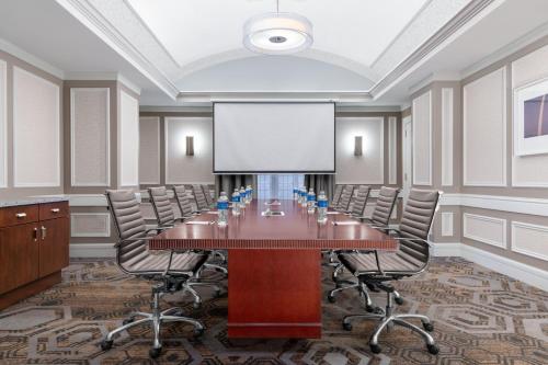 a conference room with a large table and chairs at Courtyard St. Louis Downtown/Convention Center in Saint Louis