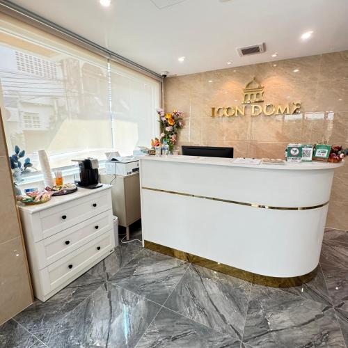 a kitchen with a white counter and a white dresser at Icon Dome Bangkok in Bangkok