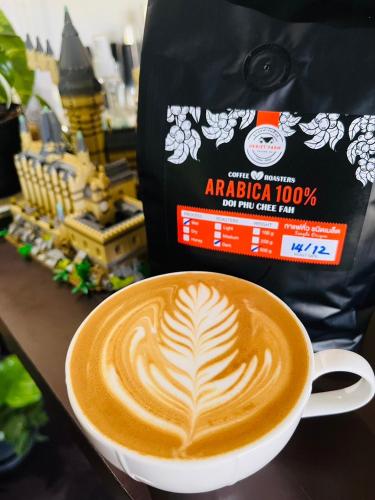 a cup of coffee on a table with a bag at อุกฤษฟาร์มฮิลล์ ภูชี้ฟ้า Ukrist farm hill in Thoeng