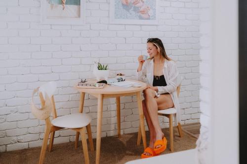 a woman sitting at a table with a cup of coffee at Mulwala Resort in Mulwala