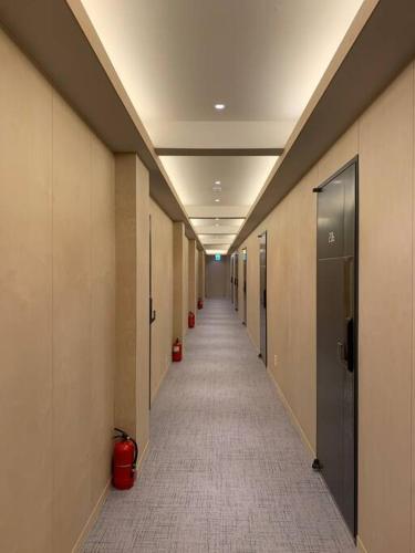 a hallway of an office building with a long corridor at Mumune Stay in Seoul