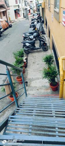 a row of motorcycles parked next to a building at Manjushree Lodging in Bengaluru