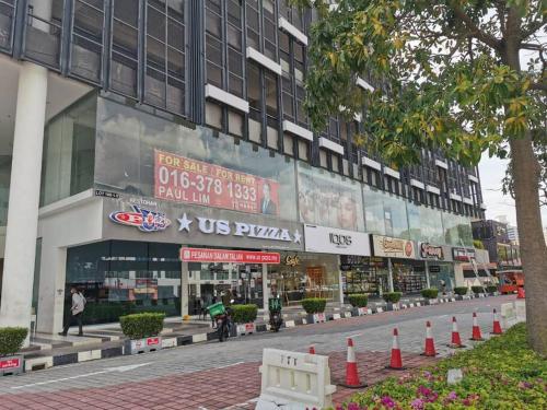 a building with a street with orange cones in front of it at LM HomeyC 3BR Family Suite for 4-14 Pax with Nexflix & Coway Water Purifier in Tanjong Tokong