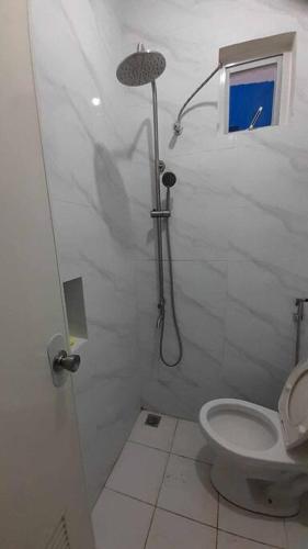 a bathroom with a shower and a toilet at Villa with Private Pool Overlooking Taal Lake in Kinalaglagan