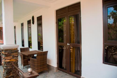 a front door of a house with a table and chairs at Travel Sanctuary residence - Luxury2 in Kampala