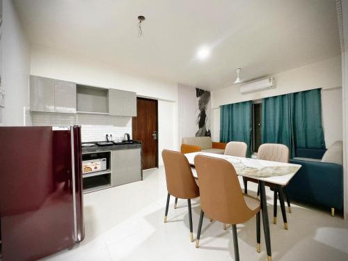 a kitchen and dining room with a table and chairs at The Orion Premium Suites in Mumbai