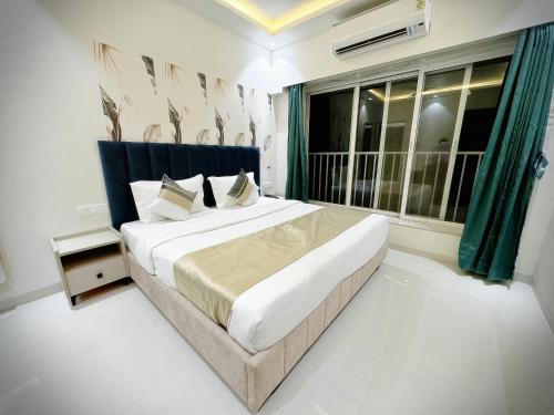 a bedroom with a large bed and a window at The Orion Premium Suites in Mumbai