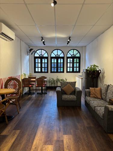 a living room with two couches and a table at Victoria Pods in George Town