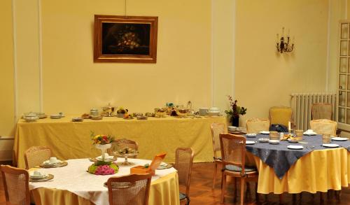 a dining room with two tables with yellow table cloth at Grande Albergo Quattro Stagioni in Rieti