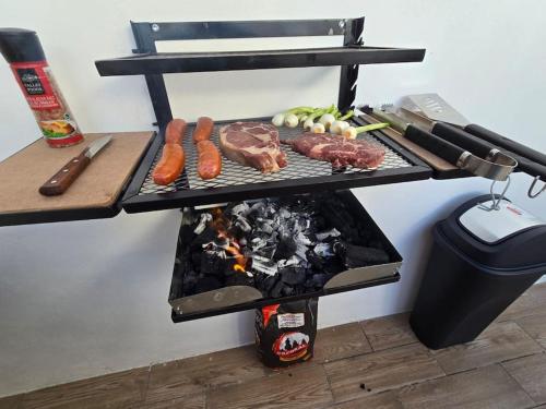 a grill with meat and vegetables on a table at Residencia en Mérida, Yucatán in Mérida