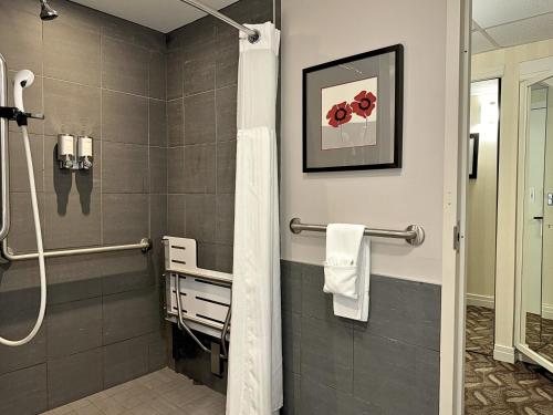 a bathroom with a shower with a shower curtain at Ivey Spencer Leadership Centre in London