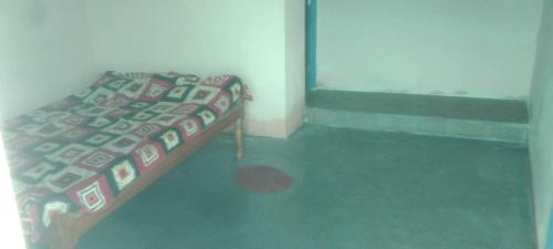 a bedroom with a bed in a room at Hotel O Chandrapur Gadchandur formerly Hotel Relax in Chāndur