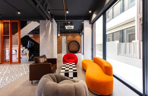 a living room with two chairs and a couch at The Hammock Hotel Global City in Ho Chi Minh City