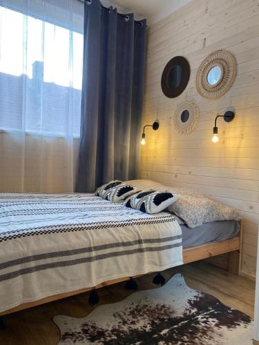a bedroom with a bed and a window at Połoninka Pokoje in Ustrzyki Górne