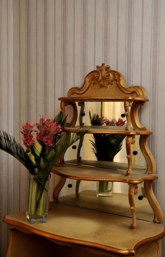a vase of flowers on a table with a vase of flowers at Grande Albergo Quattro Stagioni in Rieti