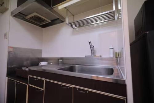 a kitchen with a stainless steel sink in a kitchen at Newly Reformed! Kawagoe Residence - 上福岡アーバンハイツ in Kamifukuoka