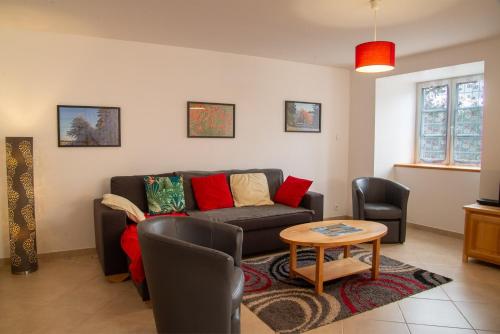 a living room with a couch and a table at Gite b les pres in Chadenet
