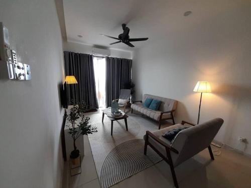 a living room with a couch and a ceiling fan at Crystal Heights Cozy House in Tupai