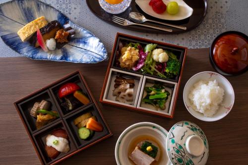 a table with plates of food and bowls of food at まち宿 壱龍 MACHIYADO ICHIRYU in Takayama