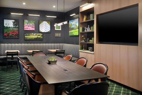 a conference room with a table and chairs and a flat screen tv at TownePlace Suites by Marriott Grovetown in Grovetown