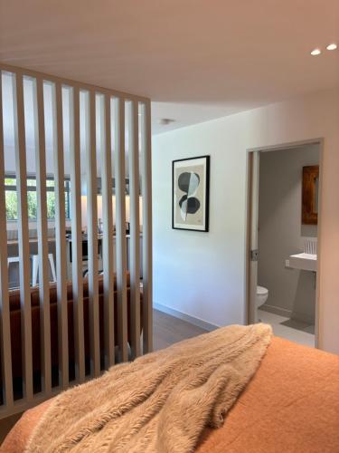 a bedroom with white walls and a bed with a crib at Morning Star Studio A in Queenstown