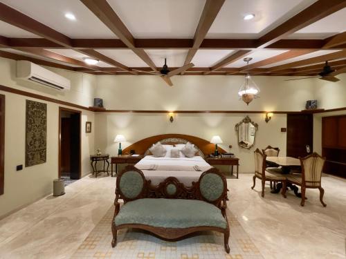 a large bedroom with a bed and a dining room at Ramsukh Resorts and Spa in Mahabaleshwar