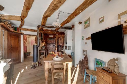 a dining room with a table and a tv on the wall at Grange Romantic Retreat Mountain View - Happy Rentals in Grange Sises
