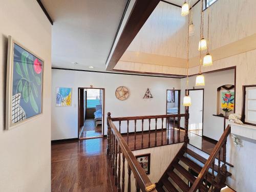 a living room with a staircase and a stair case at 那須別荘 那須エデン in Nasu