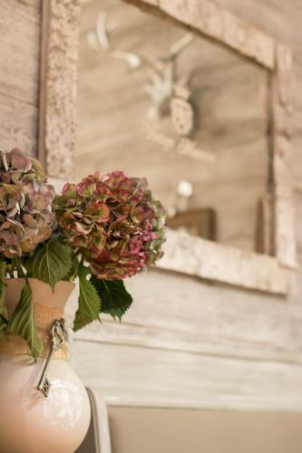 a vase with flowers in it sitting on a table at Villa Bucher - Metnitztalerhof in Friesach