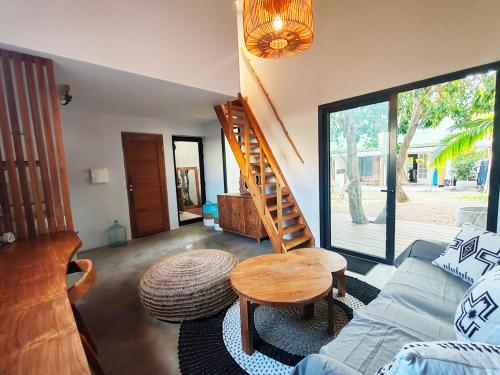 a living room with a blue couch and a wooden table at COLIVER - COLIVING A LA RÉUNION in Saint-Pierre