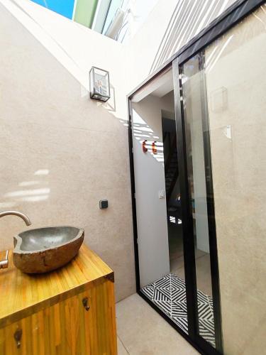 a bathroom with a stone sink on top of a counter at COLIVER - COLIVING A LA RÉUNION in Saint-Pierre