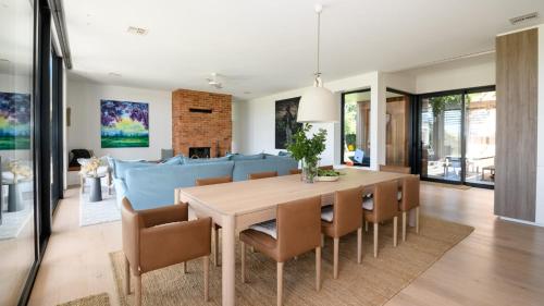 a dining room and living room with a table and chairs at Fassway Farm in Edgecombe