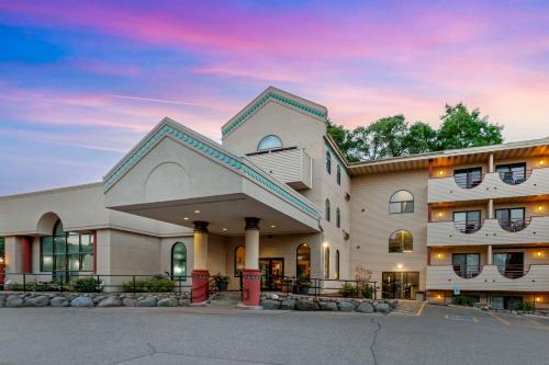 a large building with a sunset in the background at Atlantis Family Waterpark Hotel, an Ascend Collection Hotel in Wisconsin Dells