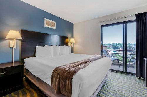 a hotel room with a bed and a balcony at Atlantis Family Waterpark Hotel, an Ascend Collection Hotel in Wisconsin Dells