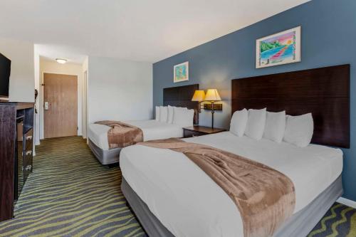 a hotel room with two beds and a television at Atlantis Family Waterpark Hotel, an Ascend Collection Hotel in Wisconsin Dells