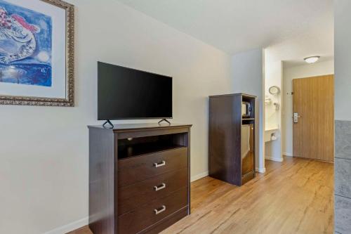 a living room with a flat screen tv on a dresser at Atlantis Family Waterpark Hotel, an Ascend Collection Hotel in Wisconsin Dells