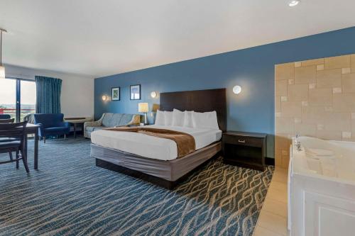 a hotel room with a bed and a bathroom at Atlantis Family Waterpark Hotel, an Ascend Collection Hotel in Wisconsin Dells