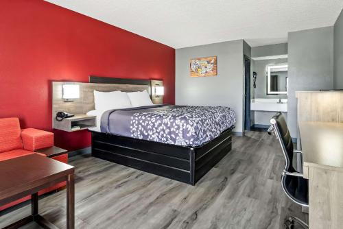 a hotel room with a bed and a couch at Econo Lodge Kennett in Kennett