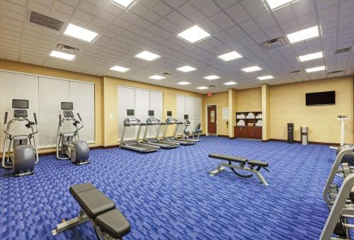 a gym with rows of treadmills and exercising machines at Clarion Hotel The Colony - Plano West in The Colony