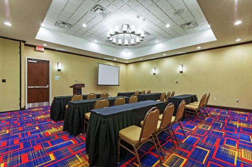 a conference room with tables and chairs and a podium at Clarion Hotel The Colony - Plano West in The Colony